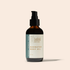 An amber glass pump bottle of Faithful Family Farmer Ozonated Body Oil with a black pump and a cream label, set against a solid pale beige background.