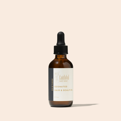 An amber glass dropper bottle of Faithful Landscaper Ozonated Hair &amp; Scalp Oil with a black dropper cap and a cream label, set against a solid pale beige background.